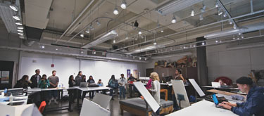 Students draw in the professionally lit studio