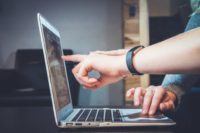 image of student pointing something on computer screen