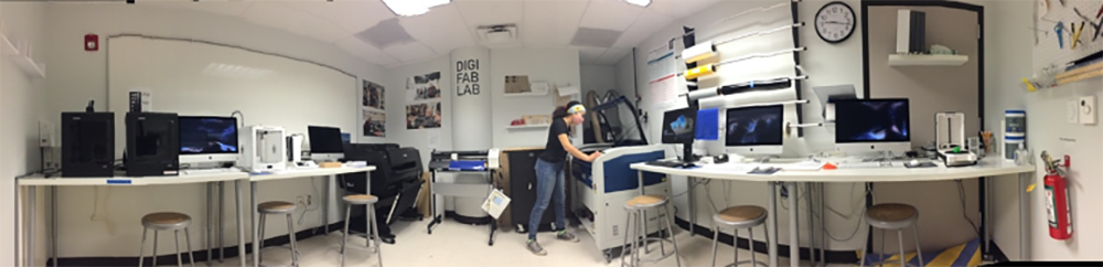 Wide-screen photo shot of DigiFabLab including Laser Cutter, 3D printers, large format digital printer, and computer workstations.