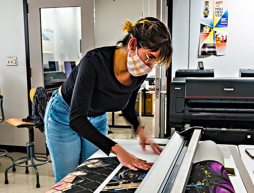 Woman cutting a large sheet of paper