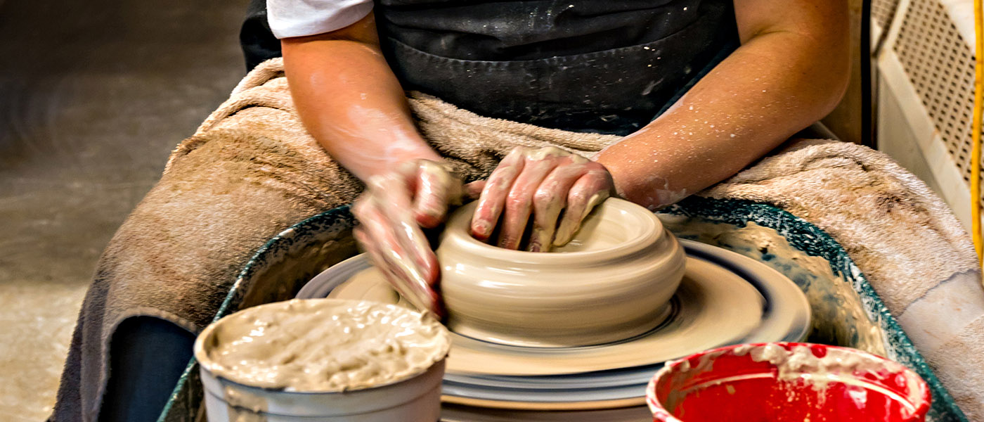 Hands working on pottery wheel. Sculptor, Potter. Human Hands