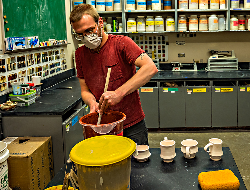 Mixing orange glaze for pottery