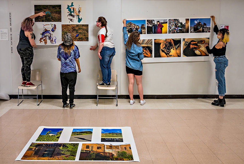 Students hanging images