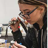 Student with a blowtorch metalworking