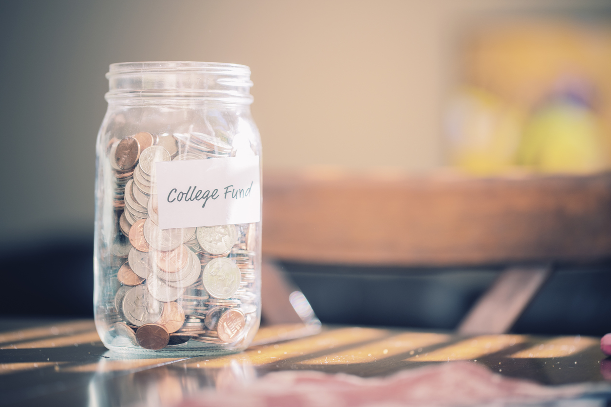 A Mason Jar full of coins marked with the words 