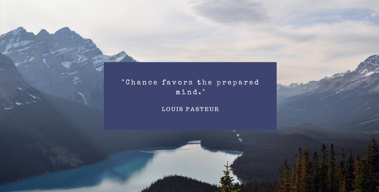 Mountains overlaid with the quote "Chance favors the prepared mind" by Louis Pasteur in a blue box 