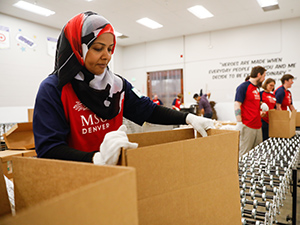 An MSU Denver volunteer loading boxes of food.