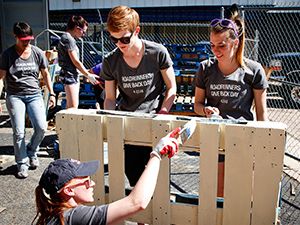 Roadrunner volunteers painting a pallet