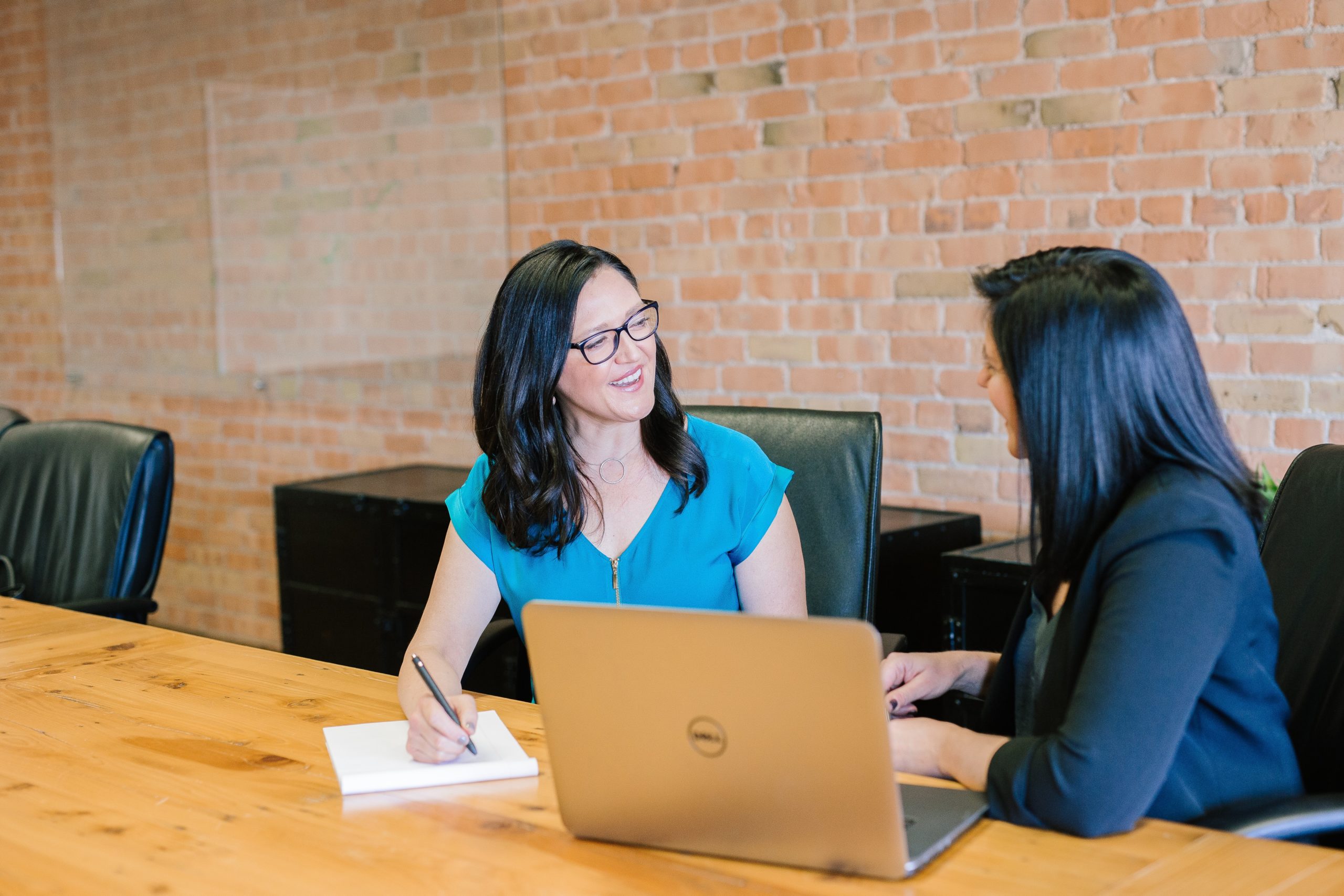 Two people sitting at a table talking to each other