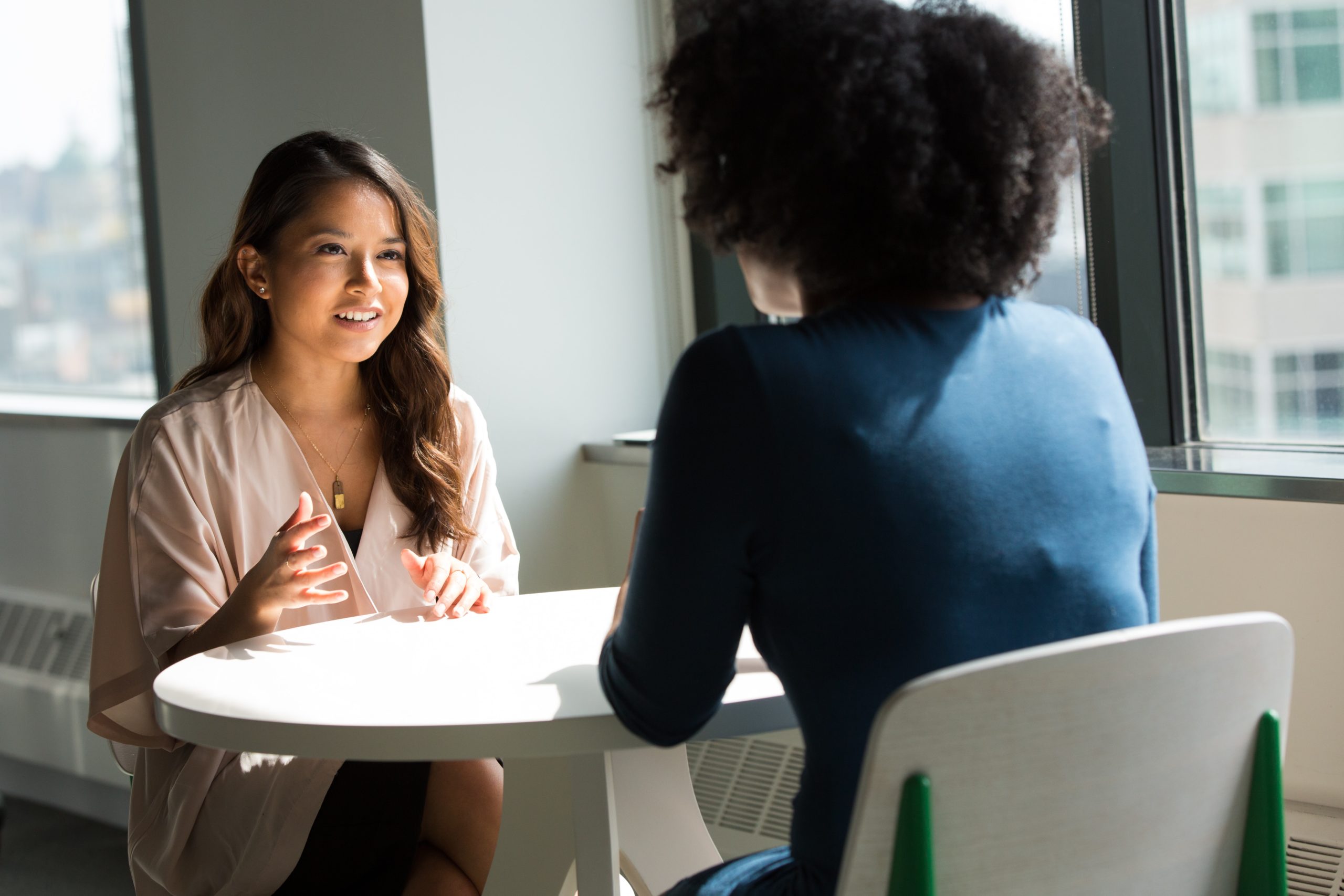 Two people talking at a table