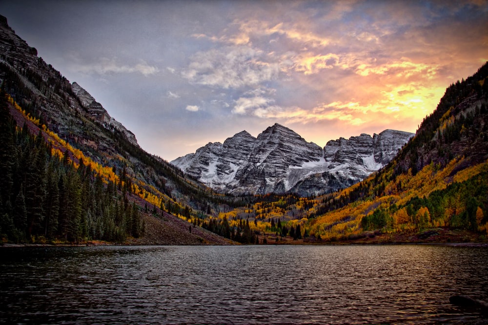 scenic photo of snowy Colorado mountains with water