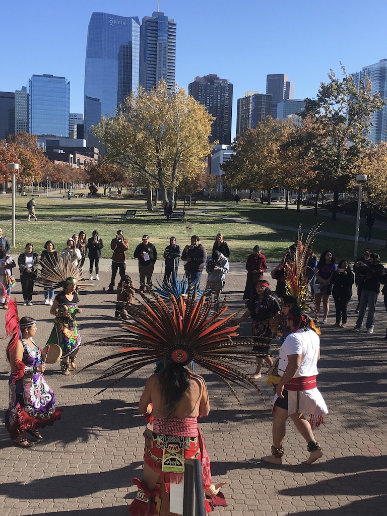 Aztec dancers outside on campus