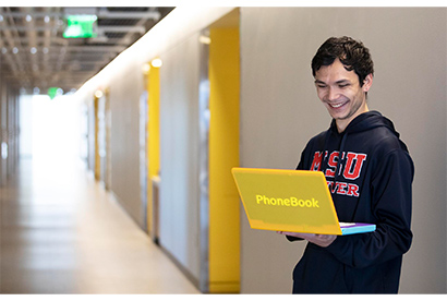 Dominique Hunt holding a yellow laptop