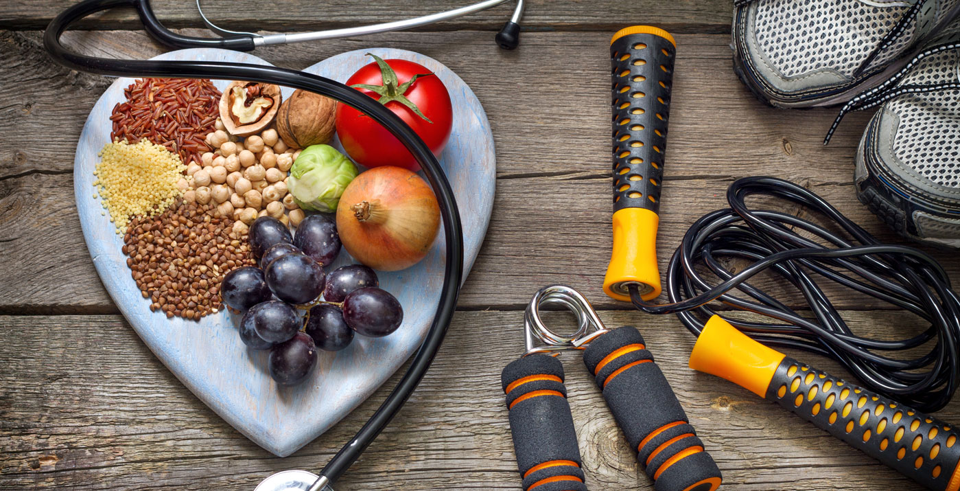 plate of vegetables, nuts, legumes, next to a stethescope, running shoes and jumping rope