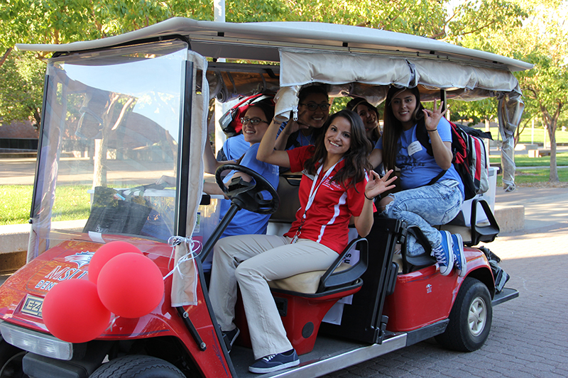 Students and team members in an MSU Denver golf cart