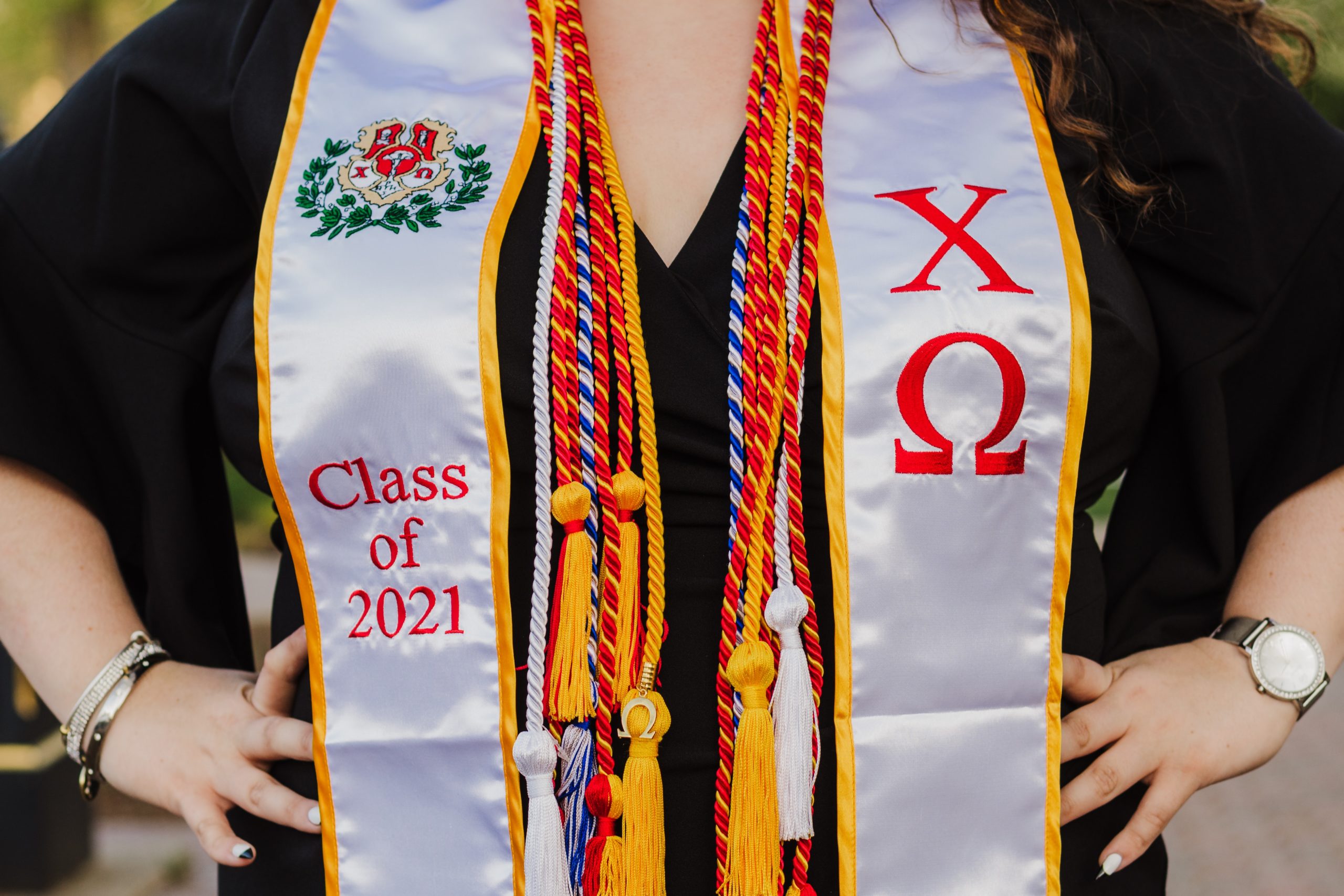 Graduation cords and stole hanging from a womans neck