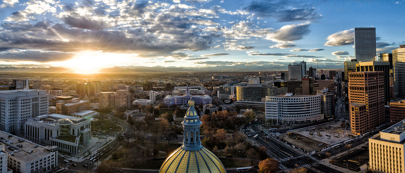 View of Denver from above at sunset with capitol building in foreground