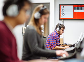 Students in a keyboard lab with headphones