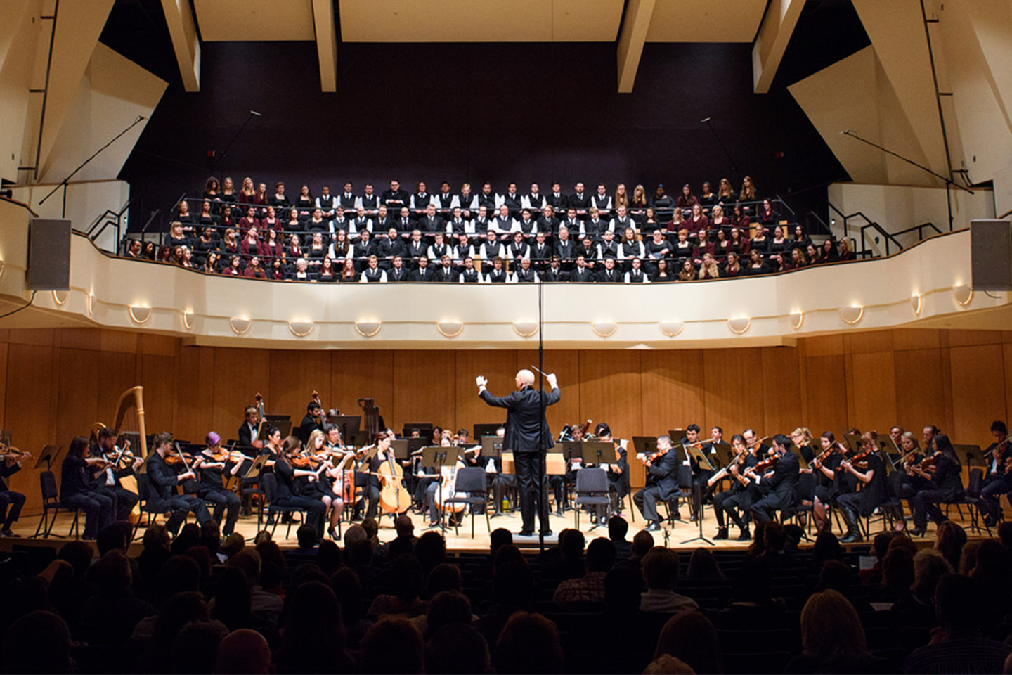 Full symphony orchestra and choir performing in the King Center Concert Hall