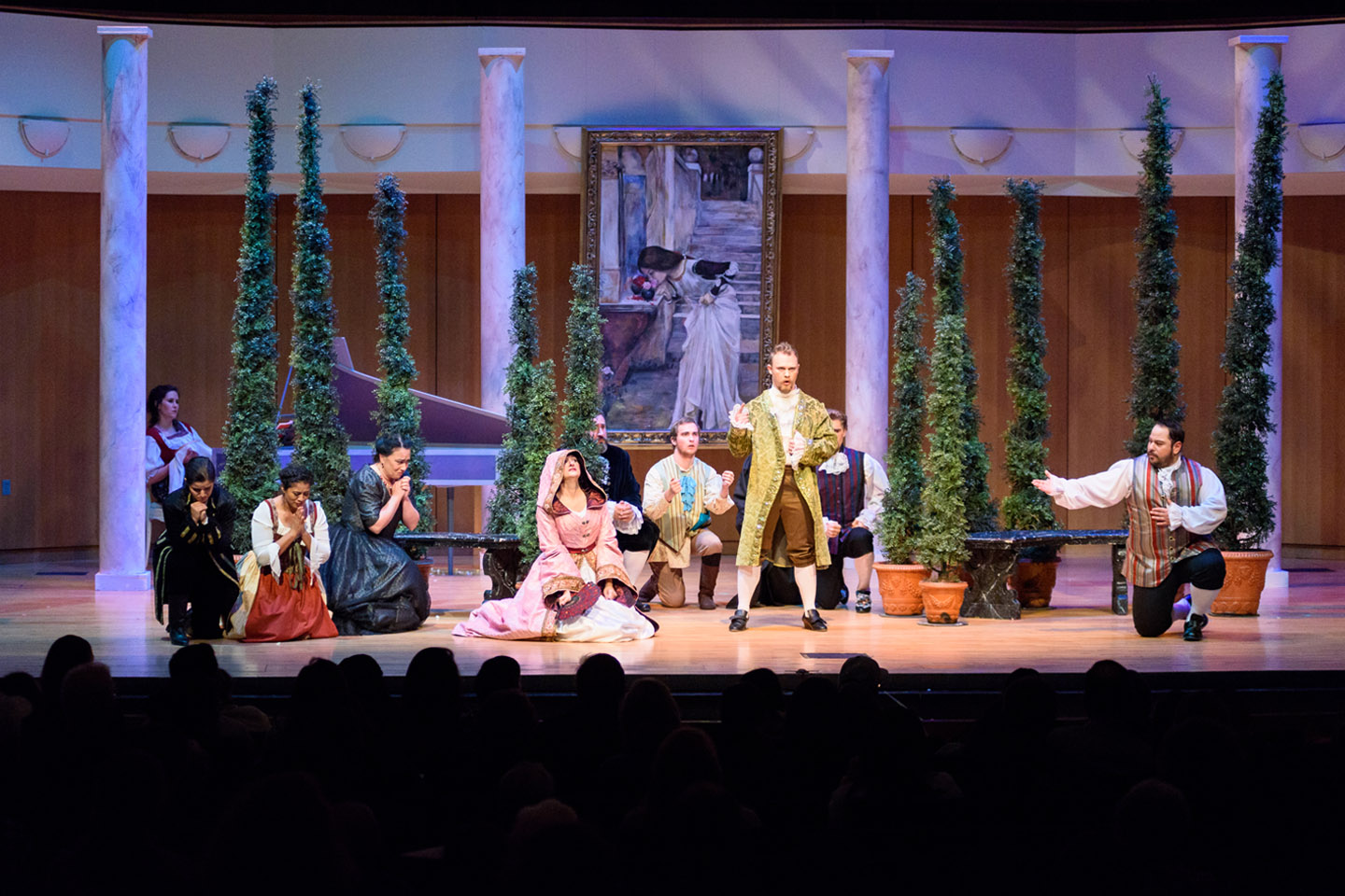 Opera cast on concert stage performing Figaro in period costumes