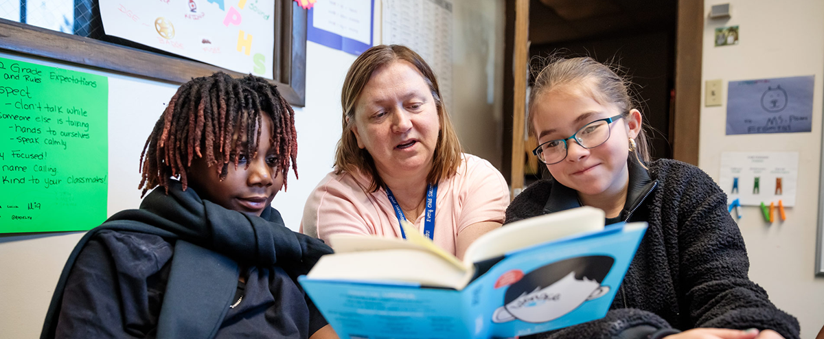 MSU Denver student Patricia Formosa reading a book to children in a classroom.