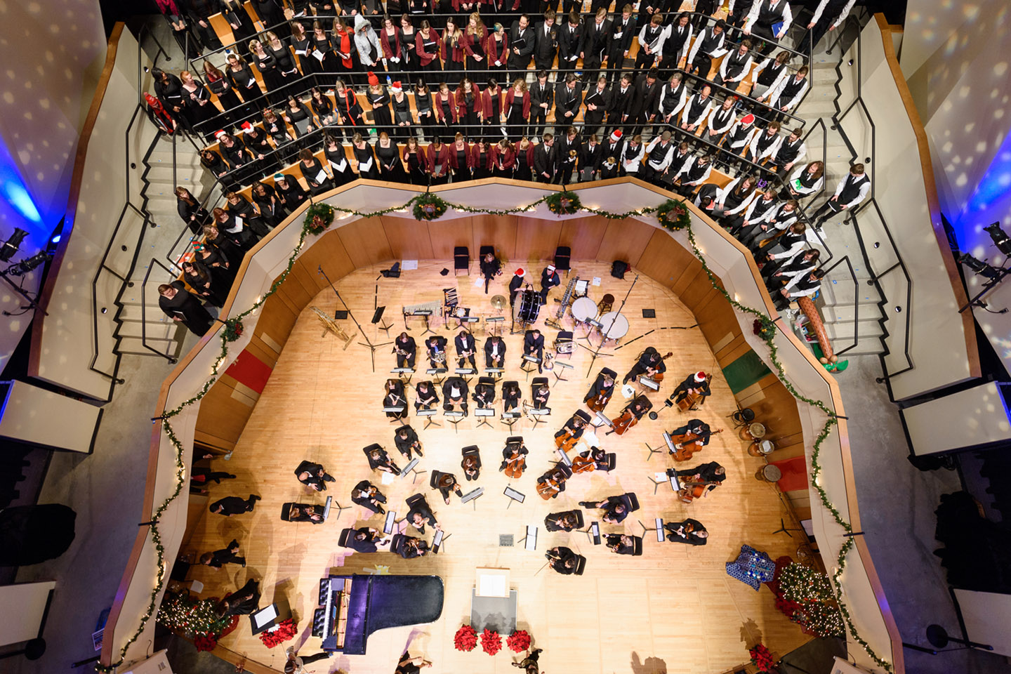 Overhead view of a full orchestra and choir performing in a concert hall