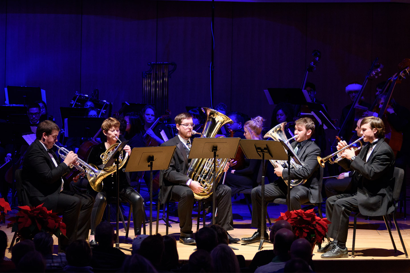 Horn Quintet performing under blue lights in the King Center Concert Hall