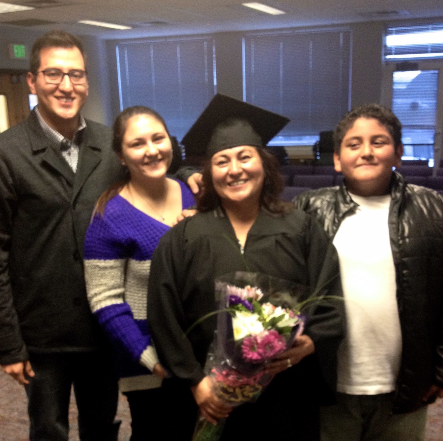 adult learner graduating with family