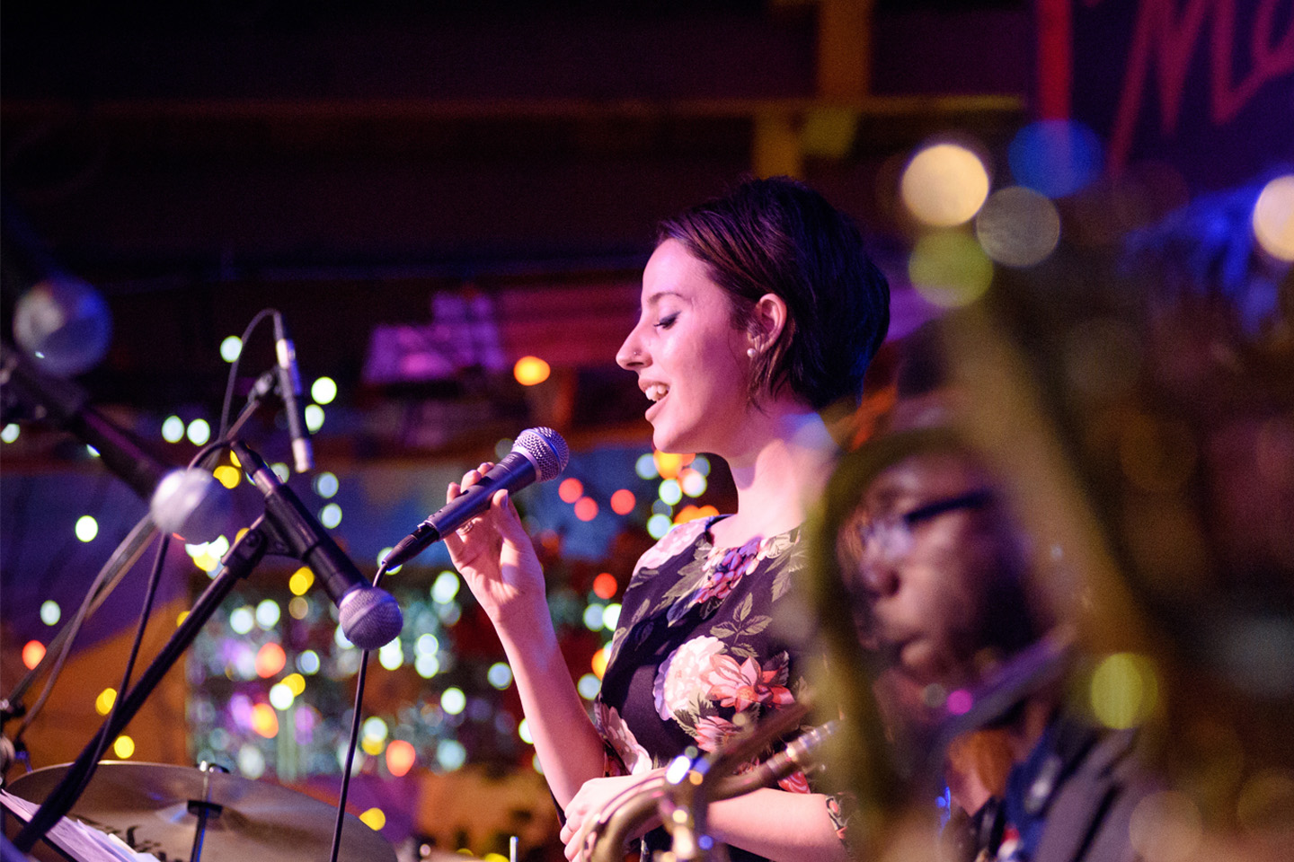 Jazz singer performing on stage with twinkling lights