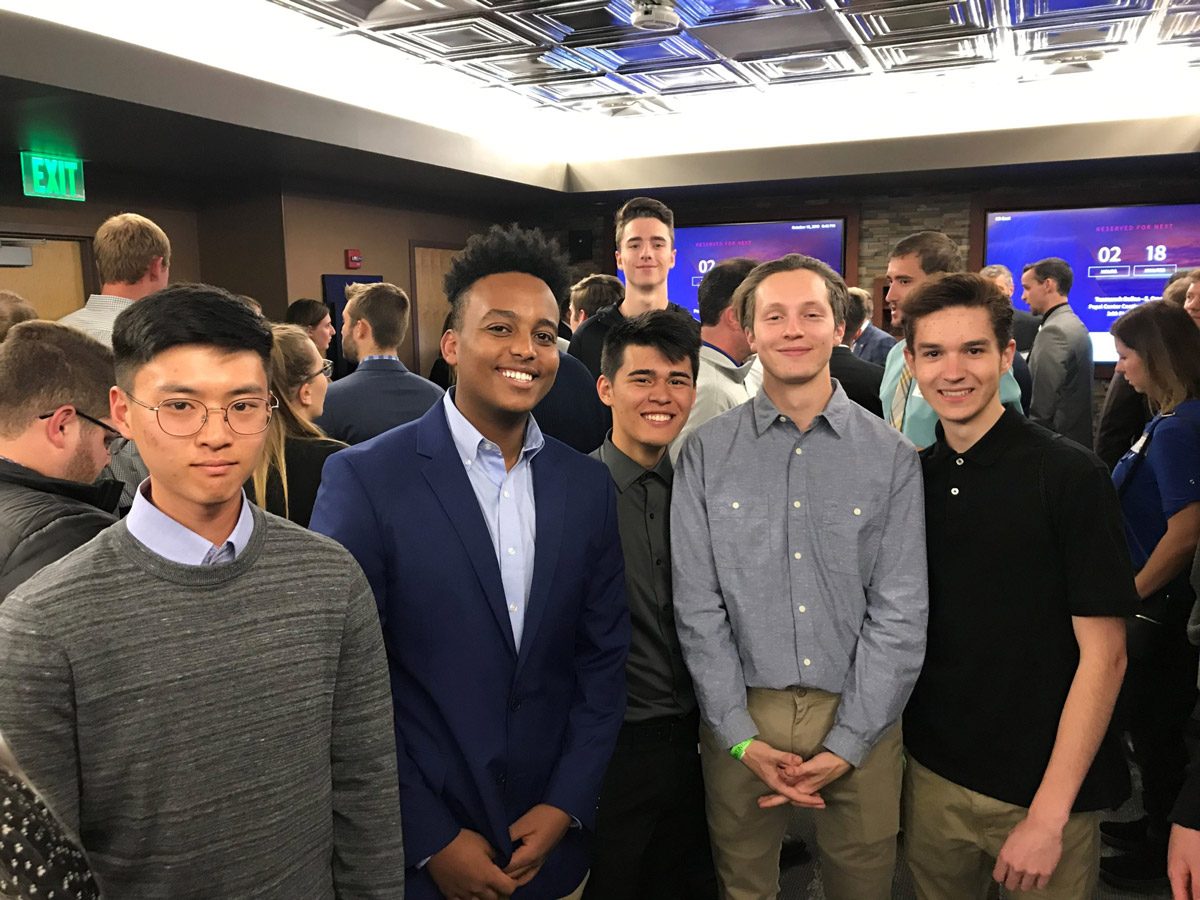 Group of male students at an indoors networking event