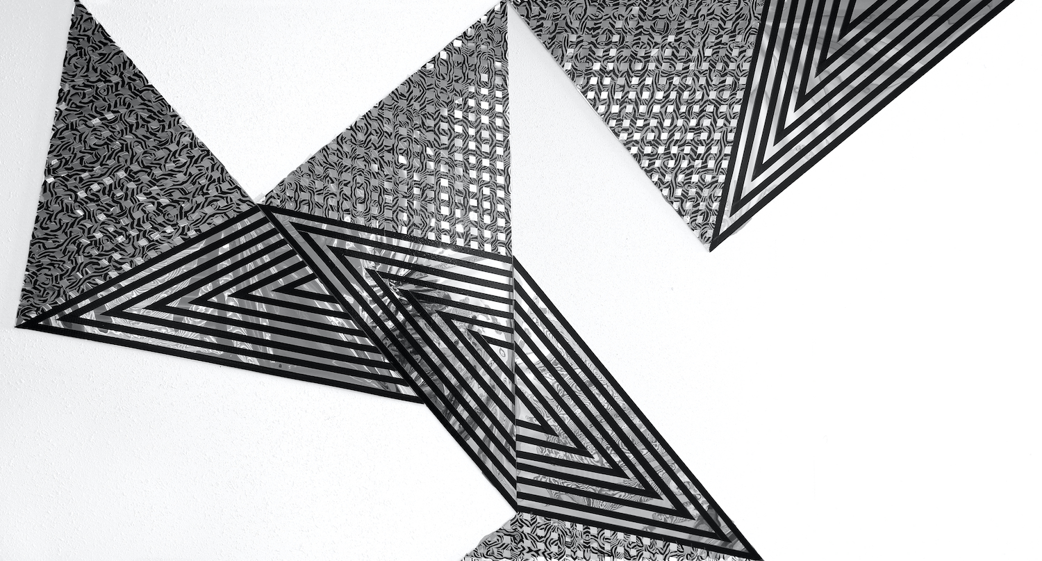 Geometric design featuring black, grey, and white tones.
