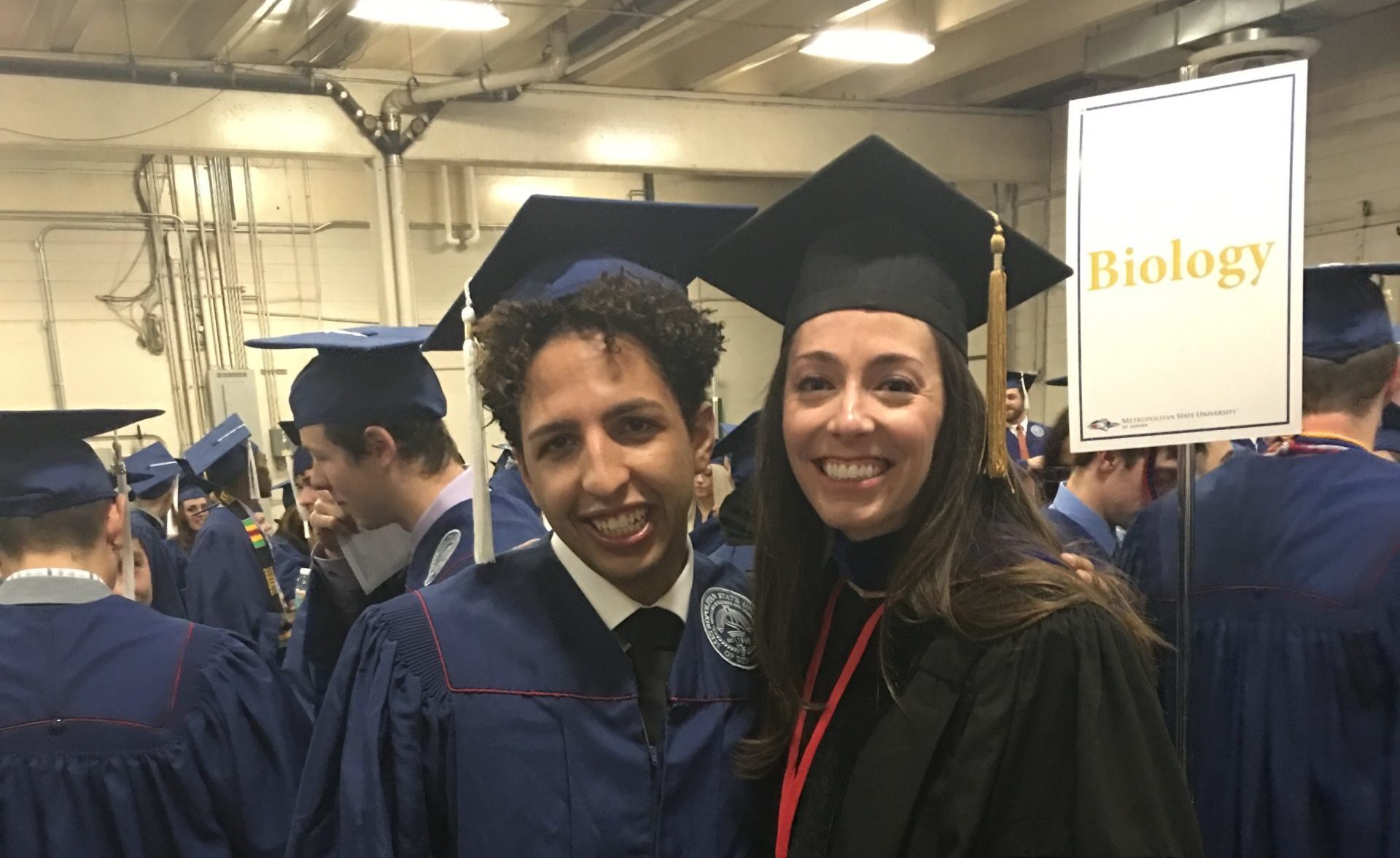 A Biology Graduate standing with Dr. Megan Filbin