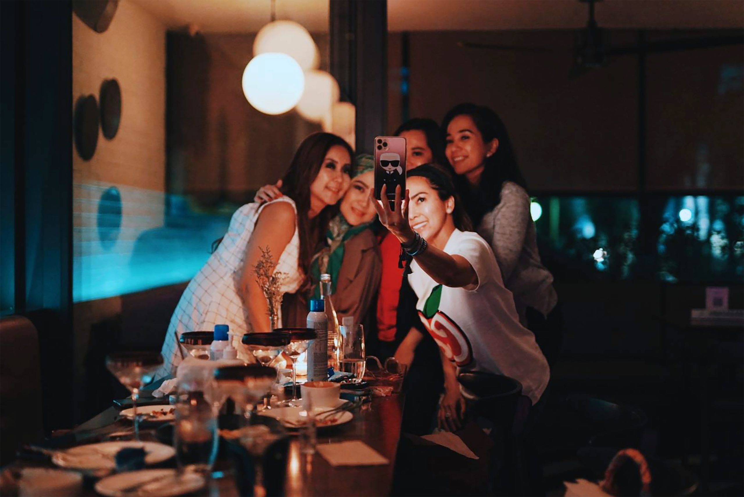 A group of women standing together taking a selfie