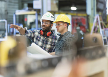 Two construction workers discussing project