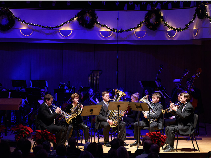 Horn Quintet performing under blue lights in the King Center Concert Hall