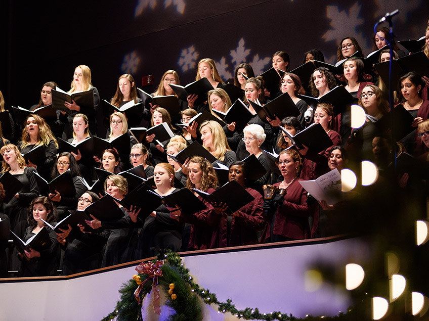 University Treble Choir singing with songbooks