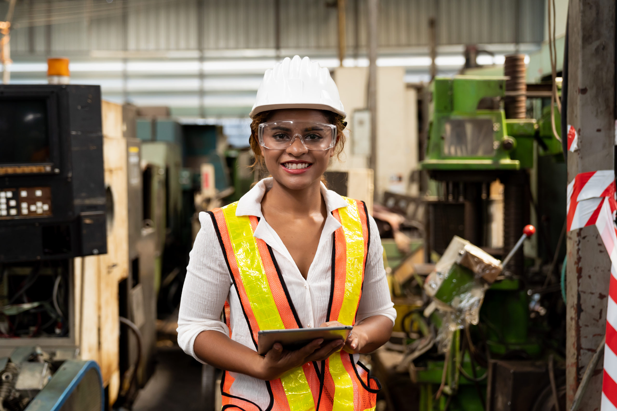 Woman in hardhat in manufacturing facility