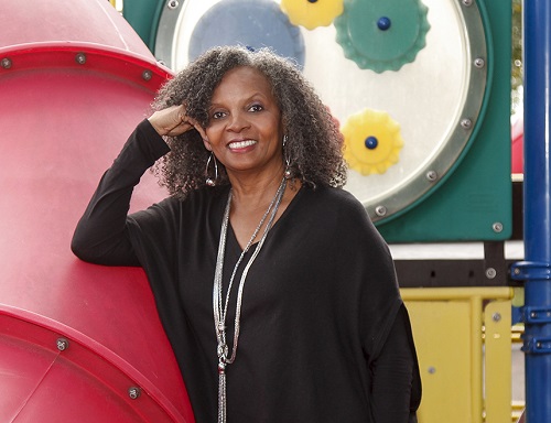 Dr. Rosemarie Allen standing in front of a playground.