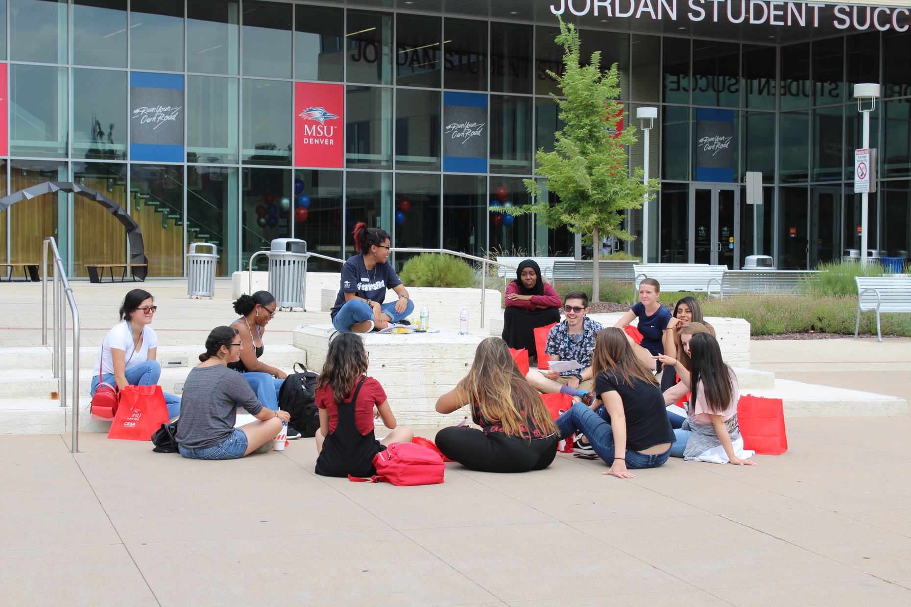 students gathering around a family leader