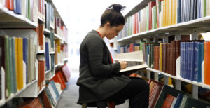 Woman reading in the Auraria library.