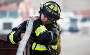 MSU Denver student and Denver Fire Academy firefighter Jacob Stephens running through drills in firefighter uniform.