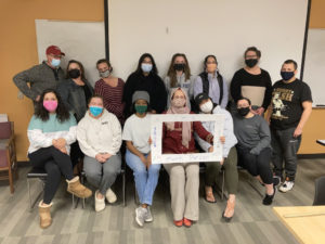 One of Dr. Konuk's classes posing with a frame that says, 