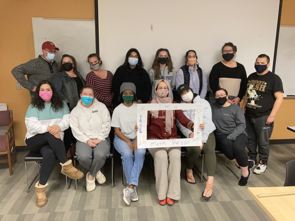 One of Dr. Konuk's classes posing with a frame that says,