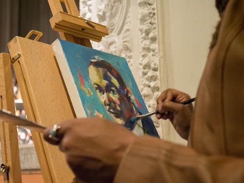 Close up of someone working on a painting of Dr. Martin Luther King Jr.