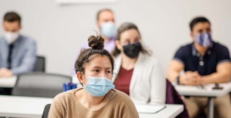 Close up of students wearing masks in class.
