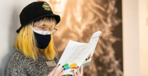 Student reading while masked in the Center for Visual Arts.