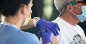 Close up of a man getting vaccinated.