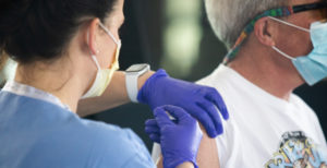 Close up of a man getting vaccinated.