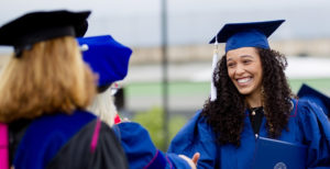 MSU Denver graduate shaking hands at Commencement.