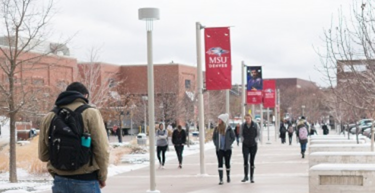 Students walking on campus on a snowy day.